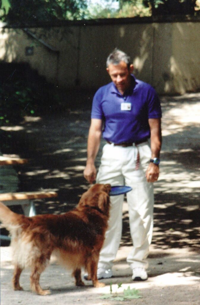 Man playing with dog and Frisbee.